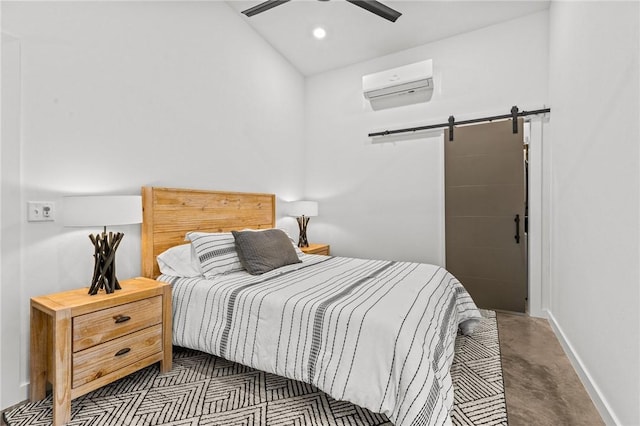 bedroom featuring a wall unit AC, a barn door, and ceiling fan