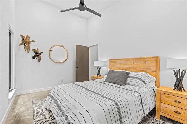 bedroom with ceiling fan and a high ceiling