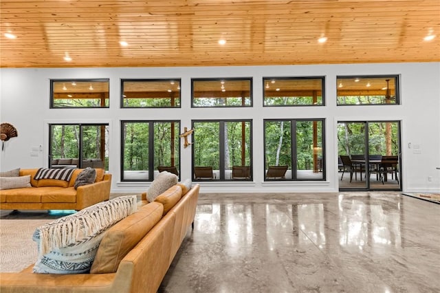 living room with a high ceiling and wooden ceiling