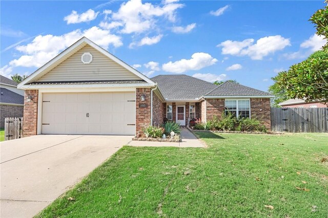 ranch-style home featuring a garage and a front lawn