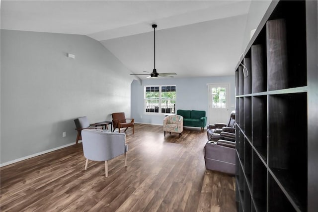 living room featuring lofted ceiling, wood-type flooring, and ceiling fan