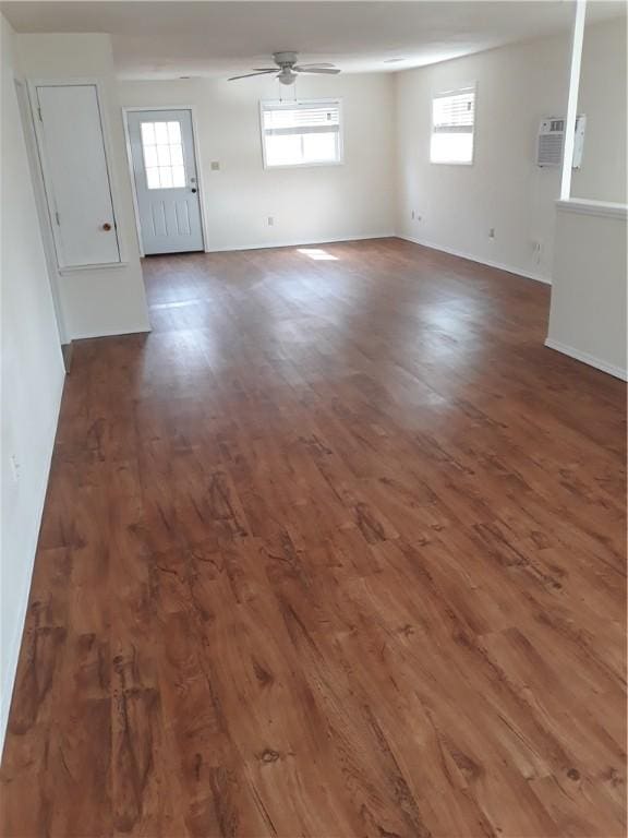 unfurnished room with dark hardwood / wood-style floors, ceiling fan, and a wall mounted AC