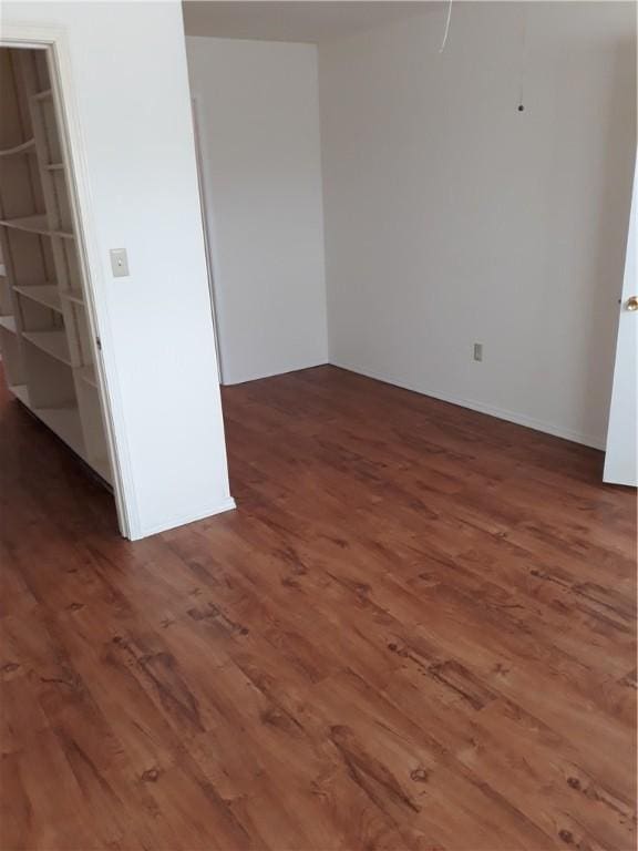 spare room featuring dark hardwood / wood-style floors