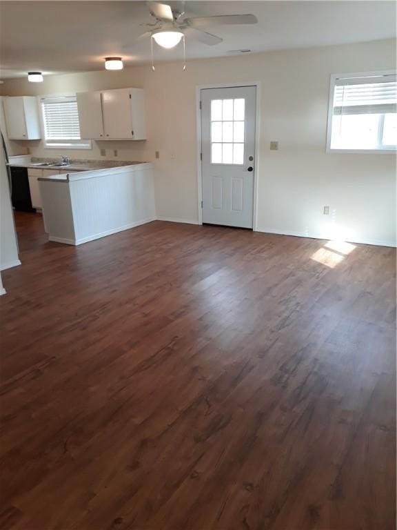 kitchen featuring kitchen peninsula, ceiling fan, sink, white cabinets, and dark hardwood / wood-style floors