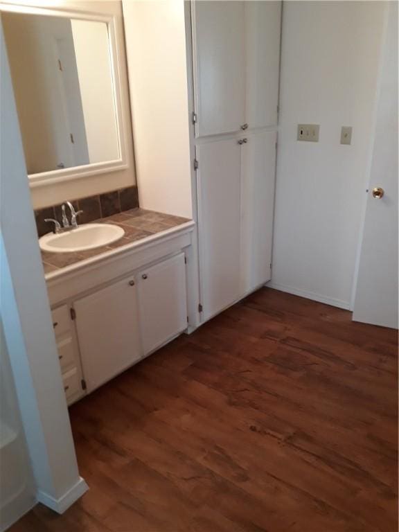 bathroom with hardwood / wood-style floors and vanity