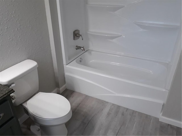 full bathroom featuring hardwood / wood-style floors, vanity, and toilet