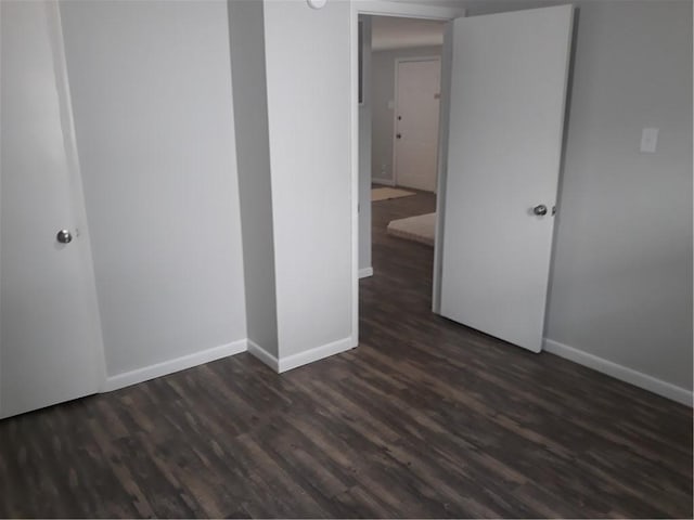 spare room featuring dark wood-type flooring