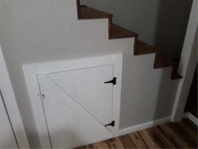 stairs featuring wood-type flooring