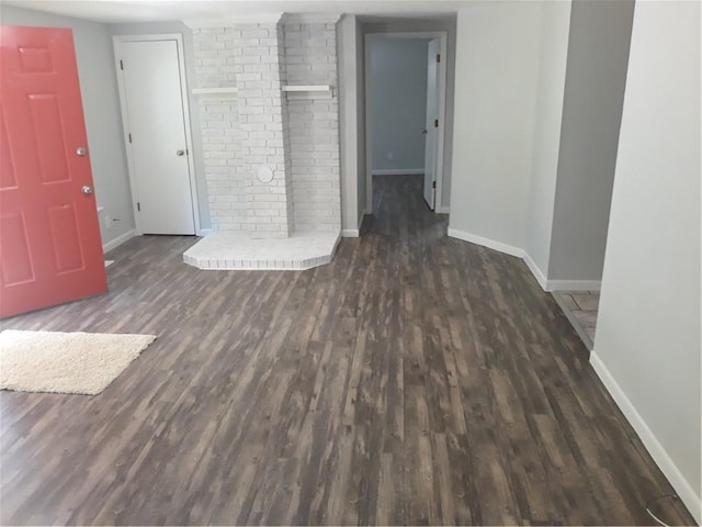 unfurnished living room featuring dark wood-type flooring