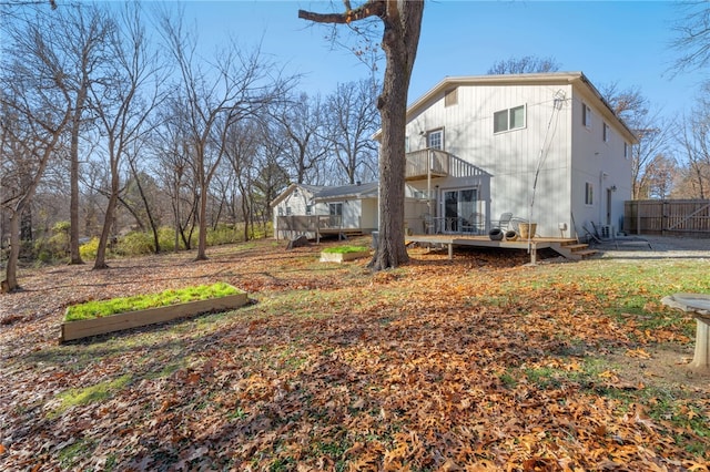 back of property featuring a wooden deck and a balcony