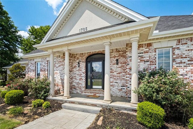 property entrance with covered porch