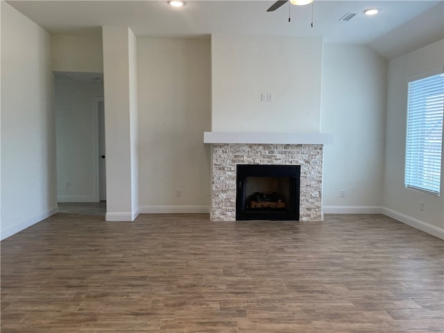 unfurnished living room with a fireplace, ceiling fan, and hardwood / wood-style floors