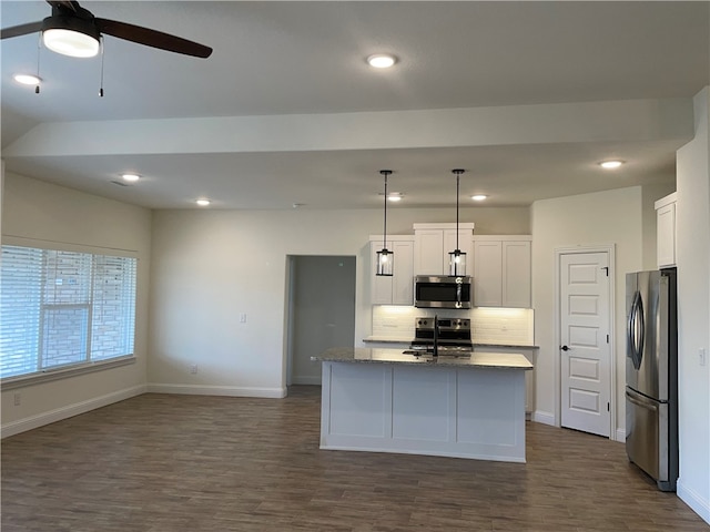 kitchen with decorative backsplash, dark hardwood / wood-style floors, hanging light fixtures, and stainless steel appliances