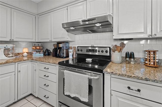 kitchen featuring stainless steel range with electric cooktop, white cabinets, decorative backsplash, light tile patterned floors, and light stone counters