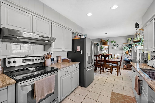 kitchen featuring decorative backsplash, appliances with stainless steel finishes, decorative light fixtures, white cabinetry, and light tile patterned flooring