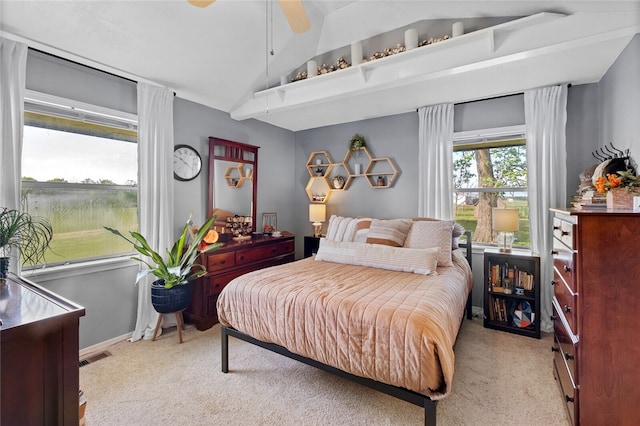 bedroom with light colored carpet, vaulted ceiling, and ceiling fan