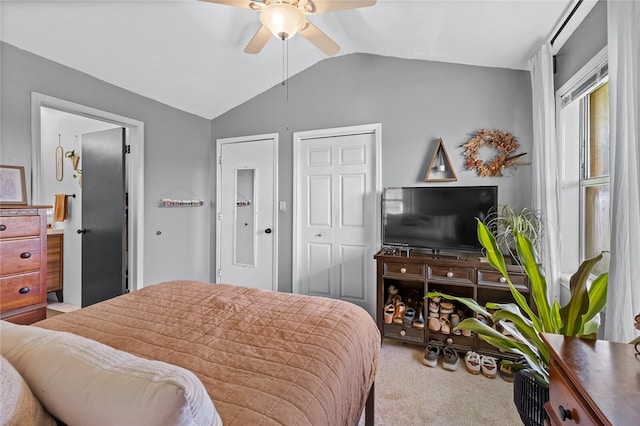 bedroom with ceiling fan, light colored carpet, and vaulted ceiling