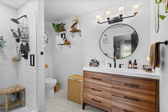 bathroom with tile patterned flooring, vanity, toilet, and an enclosed shower