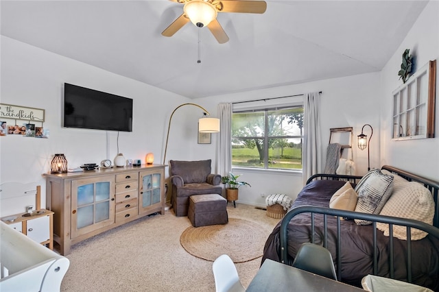 bedroom with ceiling fan, light colored carpet, and vaulted ceiling