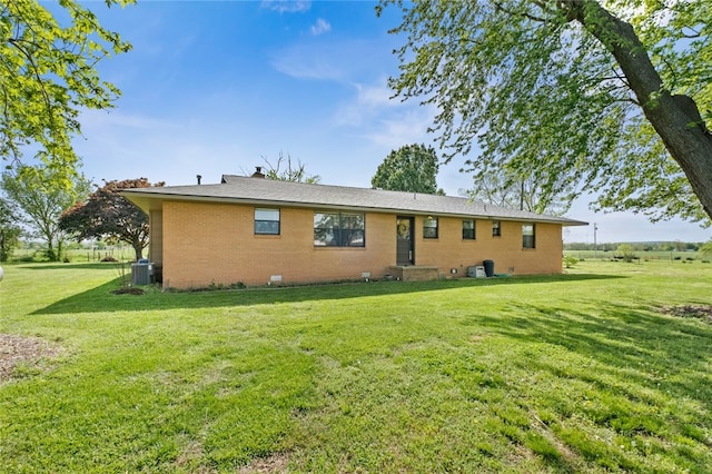 back of property featuring a yard and central AC unit