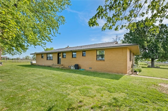 rear view of house with a yard