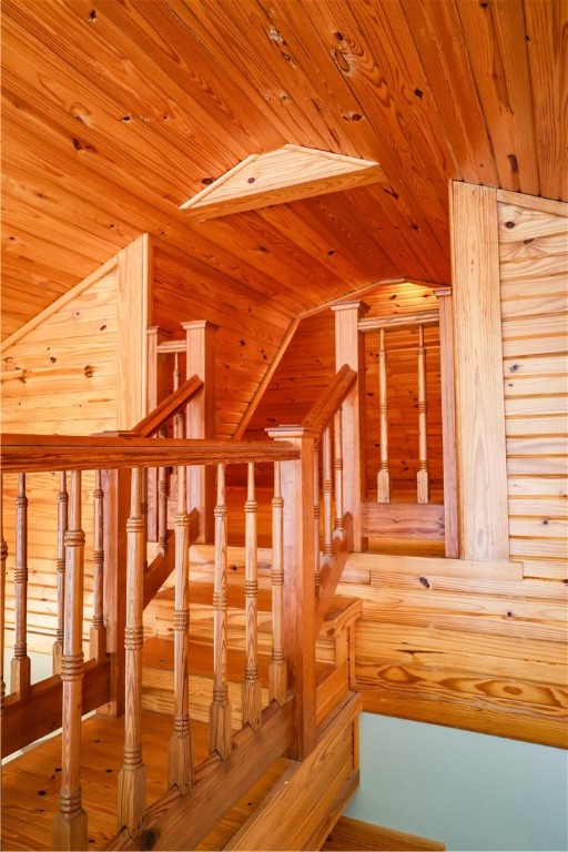 stairs with wood ceiling, lofted ceiling, and hardwood / wood-style flooring