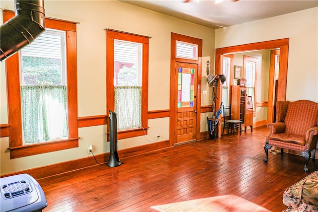 sitting room with wood-type flooring