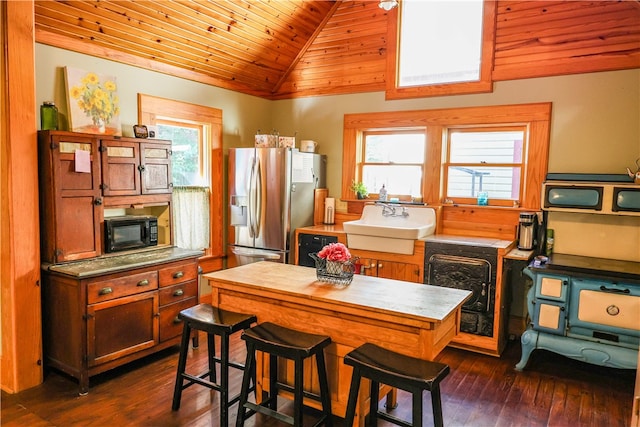 kitchen with wood ceiling, sink, lofted ceiling, dark hardwood / wood-style flooring, and stainless steel fridge