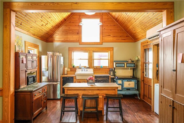 kitchen featuring stainless steel fridge, lofted ceiling with beams, dark wood-type flooring, a kitchen island, and a breakfast bar area