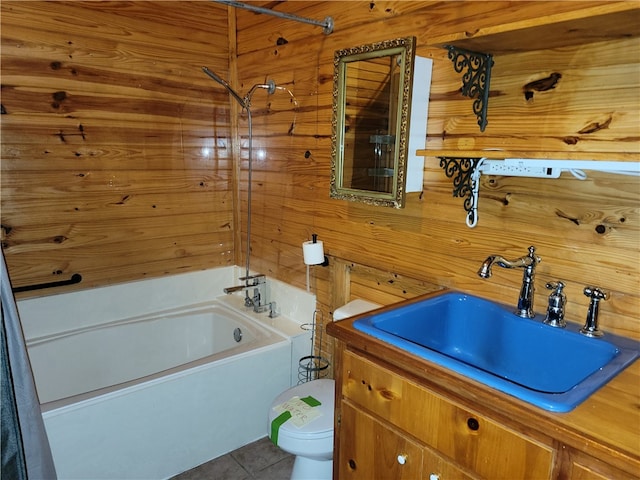 full bathroom featuring shower / washtub combination, wood walls, vanity, toilet, and tile patterned floors