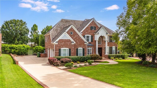 view of front of property with a front yard and a garage