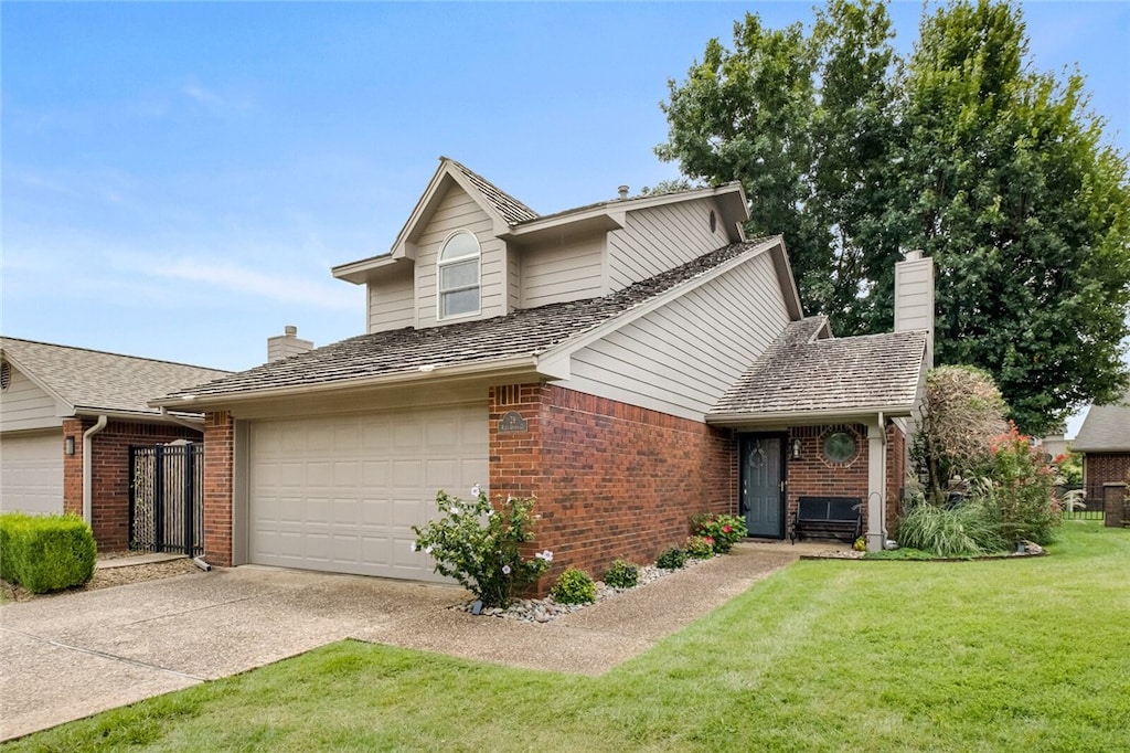 traditional home with a front lawn, concrete driveway, brick siding, and a chimney