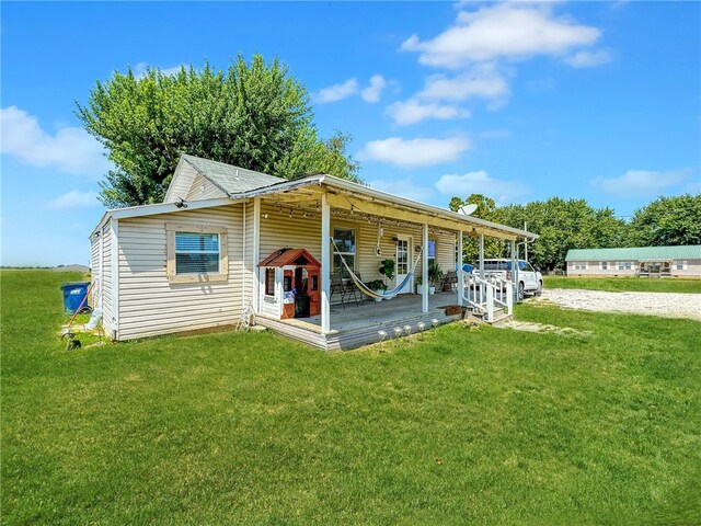 rear view of property with a yard