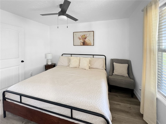 bedroom with ceiling fan and hardwood / wood-style flooring