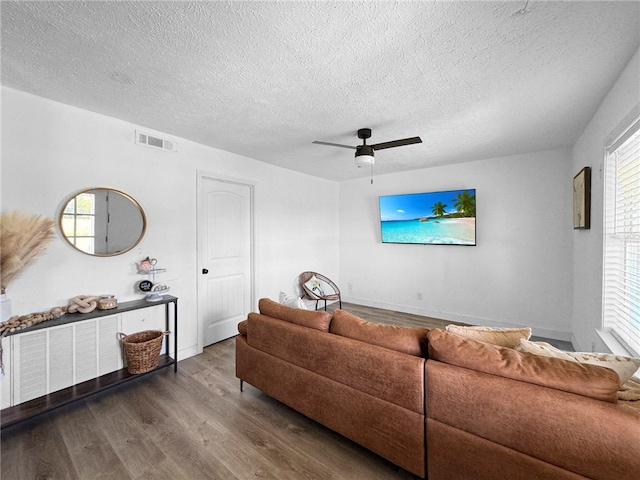 living room featuring hardwood / wood-style floors, plenty of natural light, and ceiling fan