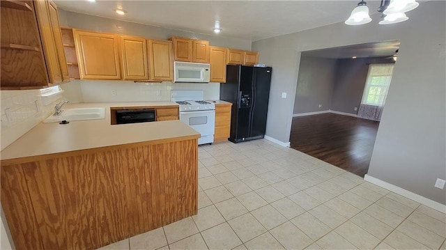 3810 Rainbow Farm Rd, Bentonville, AR 72713 - kitchen featuring pendant lighting, black appliances, sink, light tile patterned floors, and kitchen peninsula