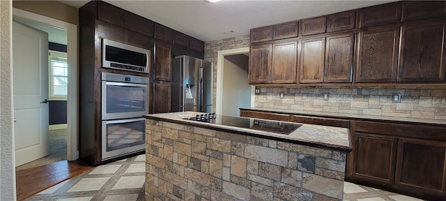 3810 Rainbow Farm Rd, Bentonville, AR 72713 - kitchen featuring dark brown cabinetry, backsplash, and stainless steel appliances