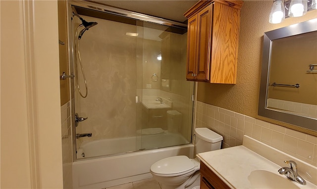 3810 Rainbow Farm Rd, Bentonville, AR 72713 - full bathroom with toilet, bath / shower combo with glass door, tile walls, vanity, and tile patterned flooring