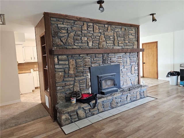 details with hardwood / wood-style flooring, a wood stove, and tasteful backsplash