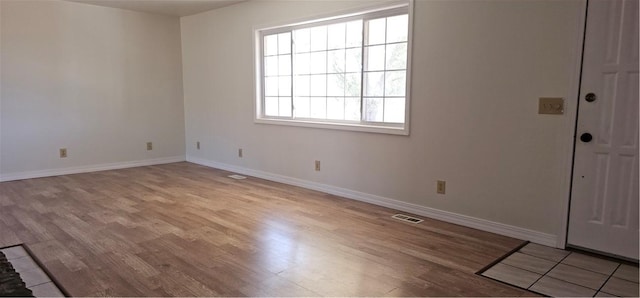 spare room featuring light hardwood / wood-style flooring