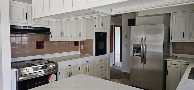 kitchen with appliances with stainless steel finishes, backsplash, light stone counters, extractor fan, and white cabinetry