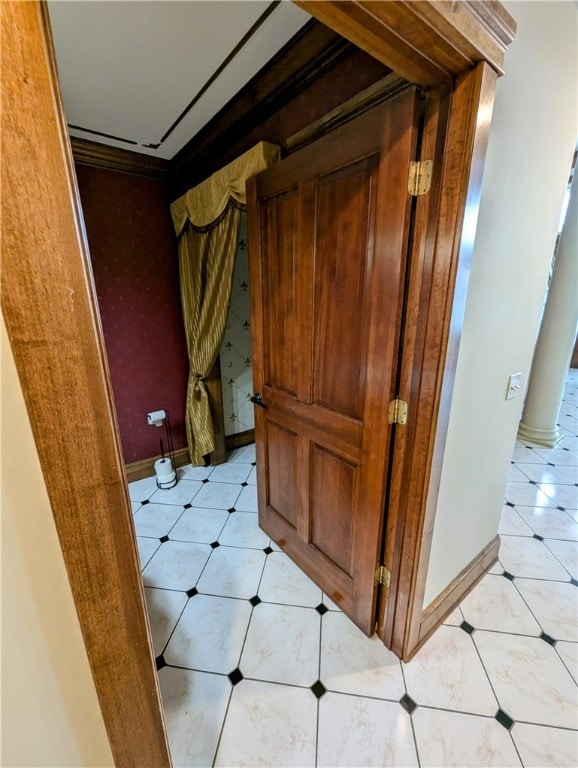 interior space with light tile patterned flooring and crown molding