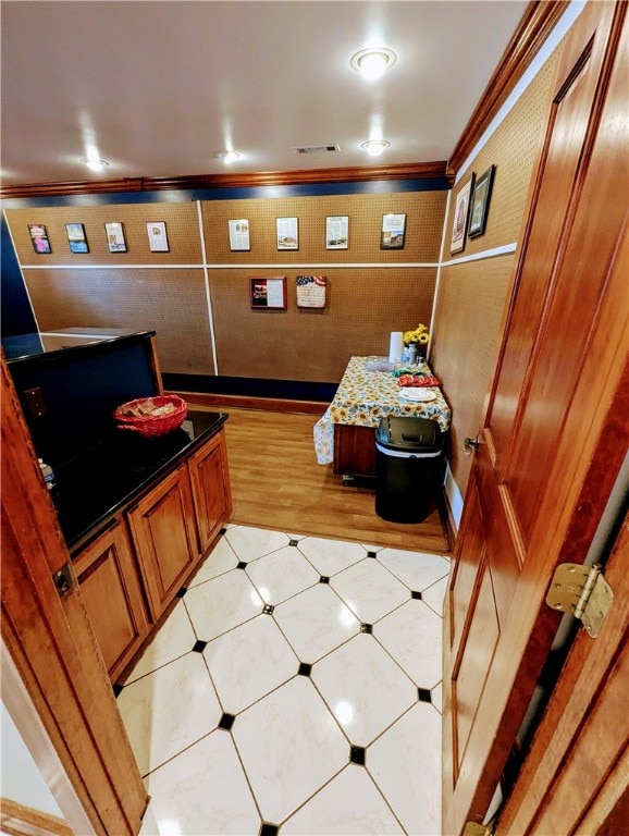 bathroom with ornamental molding and tile patterned flooring