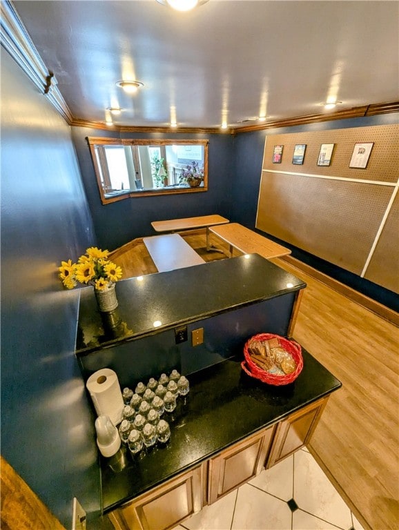 interior space with light wood-type flooring and crown molding