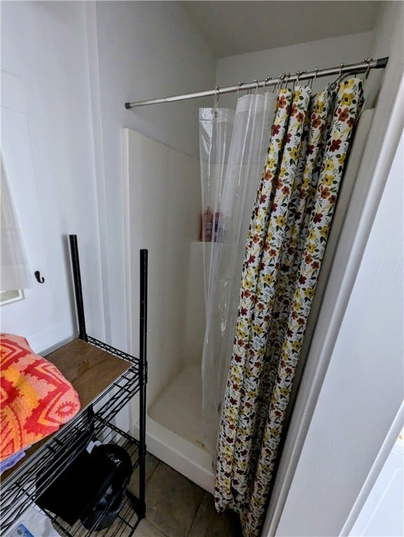 bathroom with tile patterned flooring and a shower with shower curtain