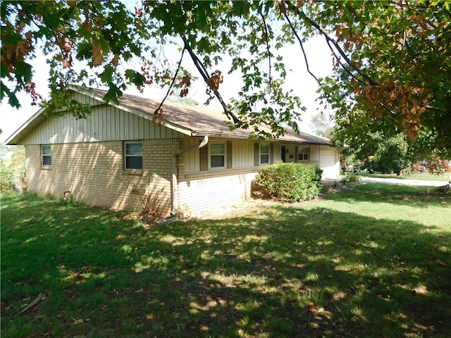 back of property featuring a lawn