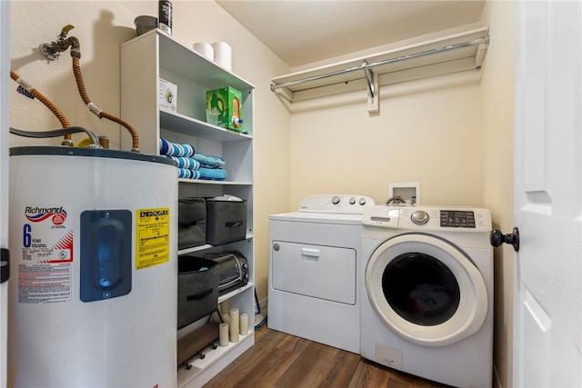 washroom with dark hardwood / wood-style flooring, washing machine and dryer, and water heater