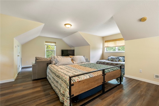 bedroom featuring dark hardwood / wood-style floors and lofted ceiling