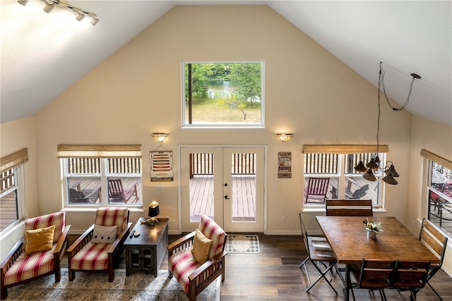 living room featuring vaulted ceiling, french doors, dark hardwood / wood-style floors, and an inviting chandelier