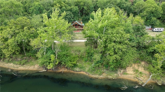 aerial view with a forest view and a water view